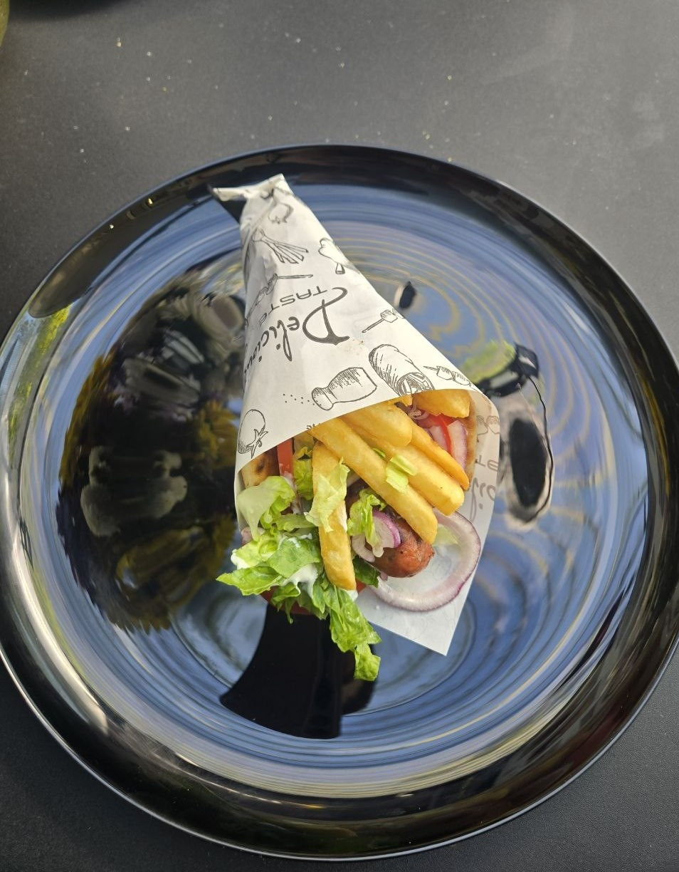 Pitta wrap with Greek sausage, tzatziki, tomato, onion, lettuce and french fries - Cristinas Greek Souvlaki Daventry