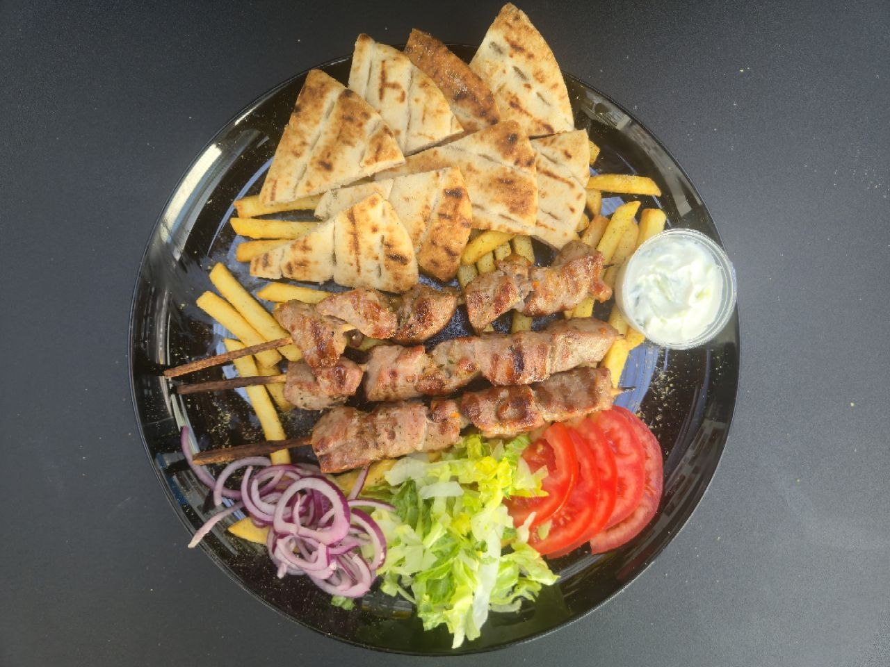 3 lamb souvlaki skewers served with pitta bread, french fries and homemade tzatziki - Cristinas Greek Souvlaki Daventry