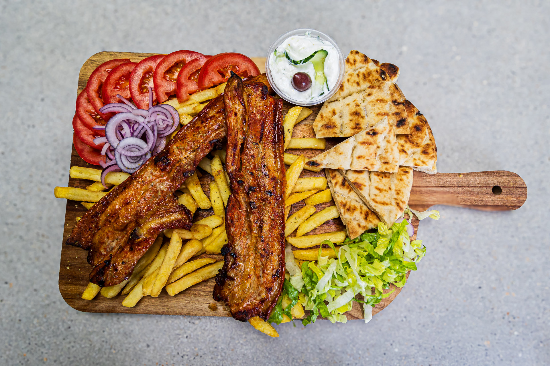 Grilled pancetta portion served with pitta bread, french fries and homemade tzatziki – Cristina's Greek Souvlaki Daventry