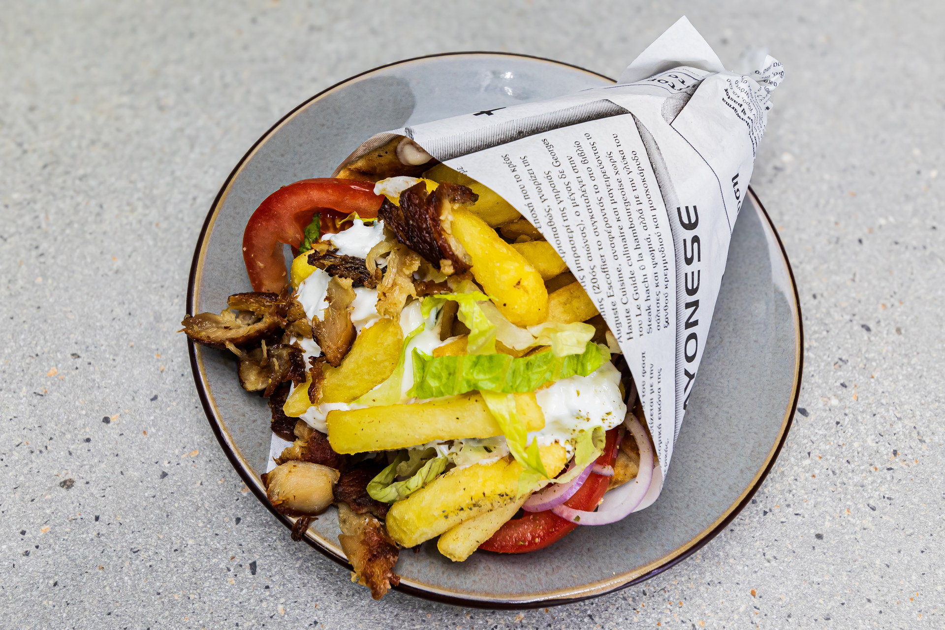 Pitta gyros pork wrap with pork gyros, tzatziki, tomato, onion, lettuce and fries - Cristinas Greek Souvlaki Daventry