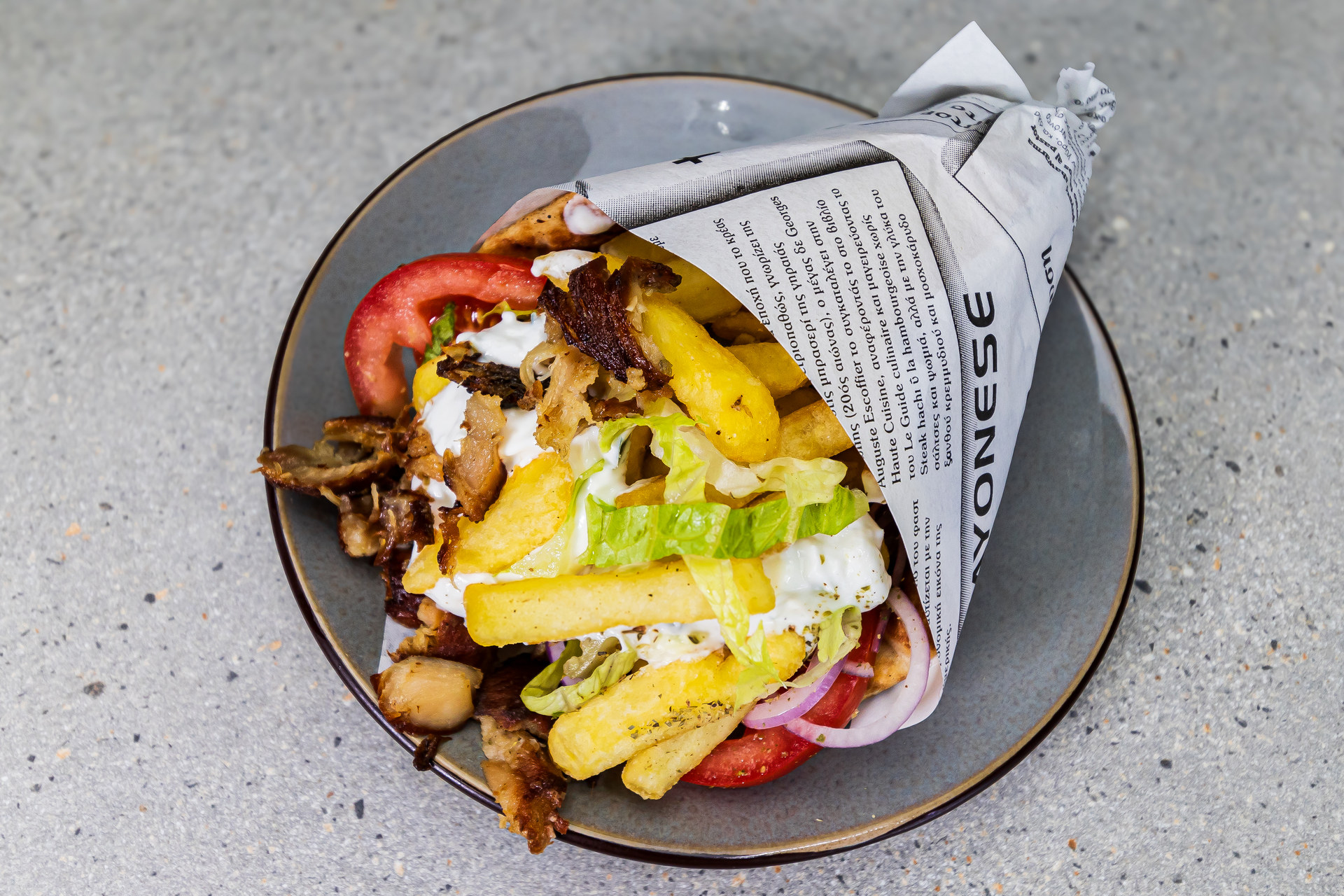 Pitta gyros mixed wrap with pork and chicken, tzatziki, tomato, onion, lettuce and fries - Cristinas Greek Souvlaki Daventry