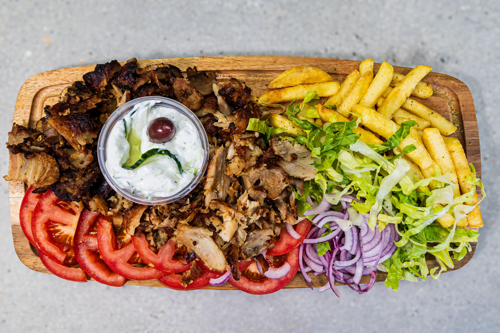 Portion of mixed pork and chicken gyros served with pitta bread, fries and homemade tzatziki - Cristinas Greek Souvlaki Daventry