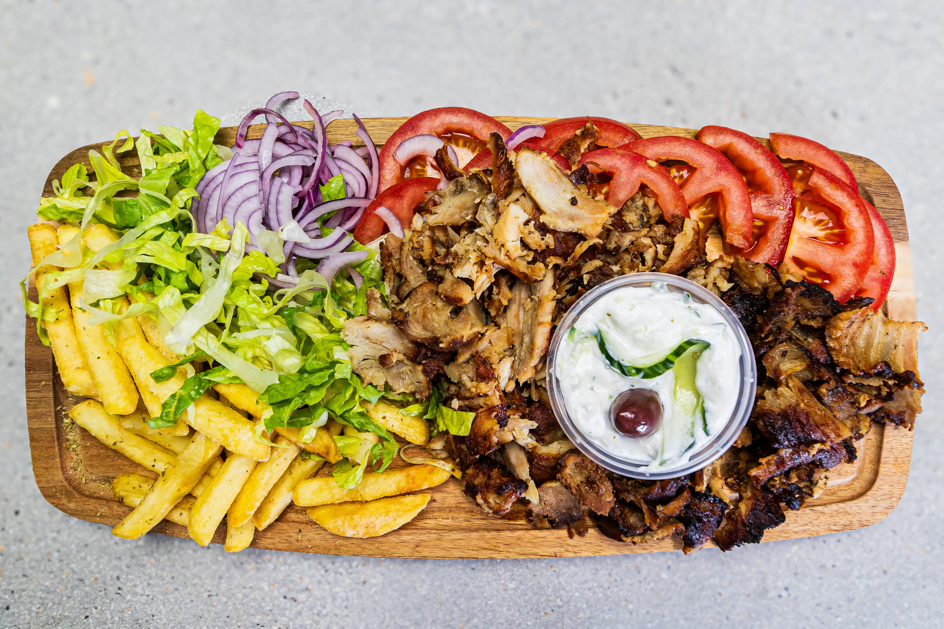 Portion of pork gyros served with pitta bread, french fries and homemade tzatziki - Cristinas Greek Souvlaki Daventry